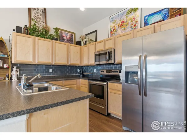 a kitchen with kitchen island a counter top space a sink and a refrigerator