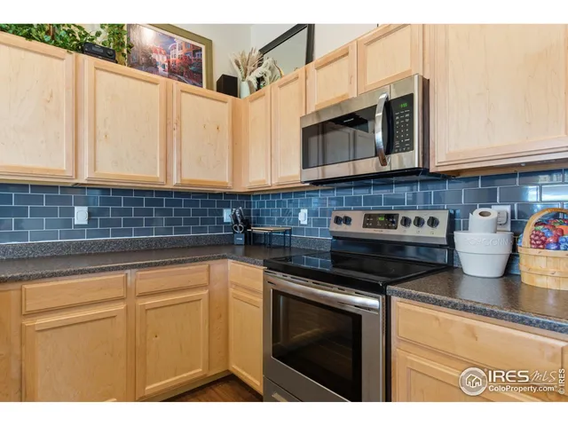 a kitchen with stainless steel appliances granite countertop a sink and a microwave