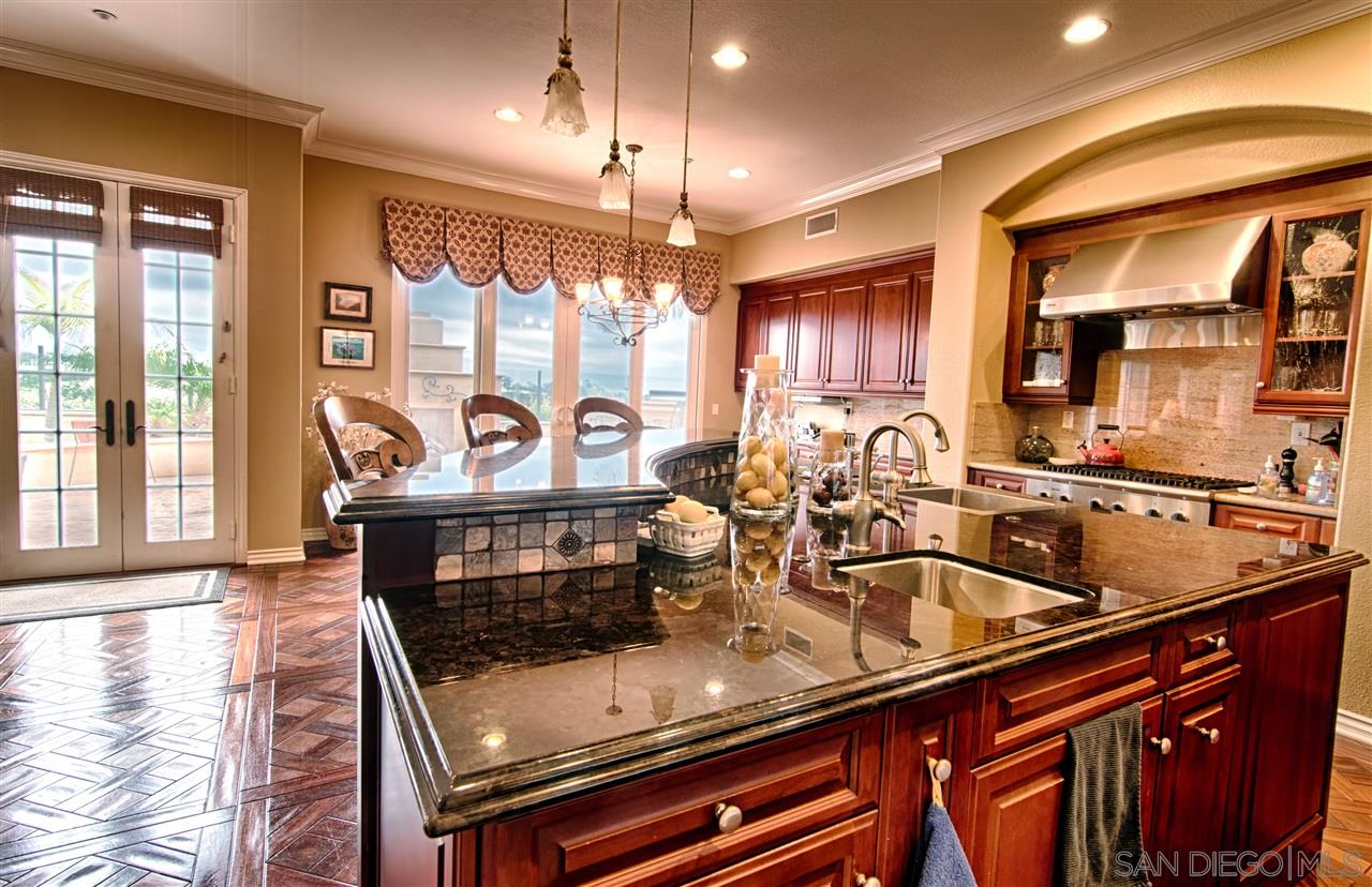 1445 Ravean Court Encinitas, CA 92024 - Photo 7 of 25 Views out kitchen windows. Gourmet upgraded with two sinks in the island, butler pantry with two drawer fridge + wine fridge. Everything you could ever want in one kitchen.