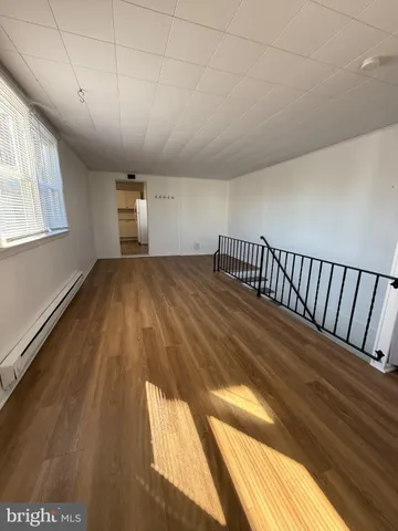 a view of hallway with wooden floor