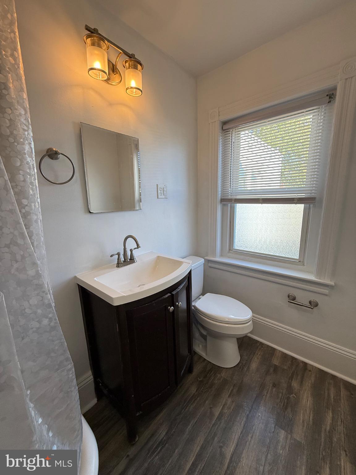 33 East 4th Street Pottstown, PA 19464 - Photo 7 of 20 a bathroom with a toilet sink and mirror