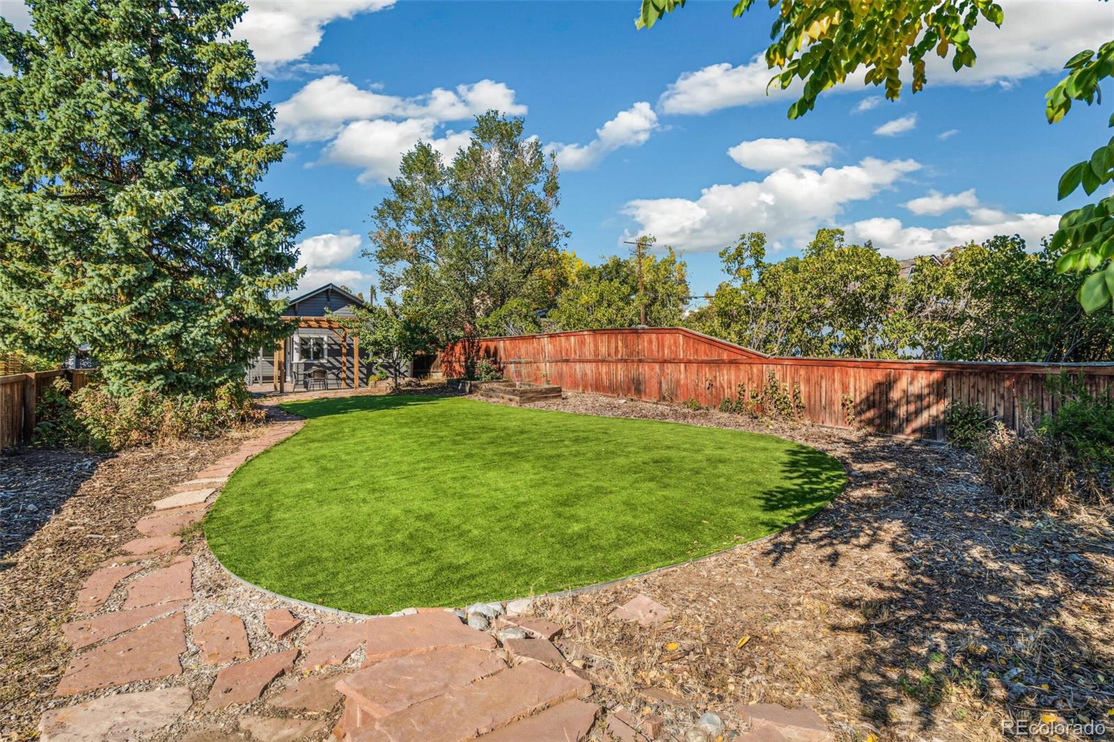 2963 Ames Street Wheat Ridge, CO 80214 - Photo 23 of 24 a view of a garden with a slide