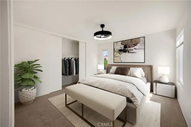 a bedroom with a bed and a potted plant