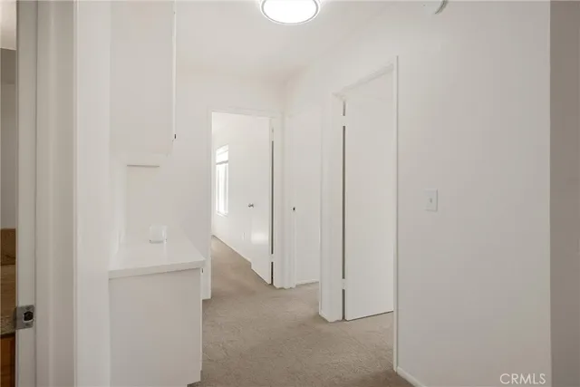 a bathroom with a granite countertop sink a toilet and a mirror