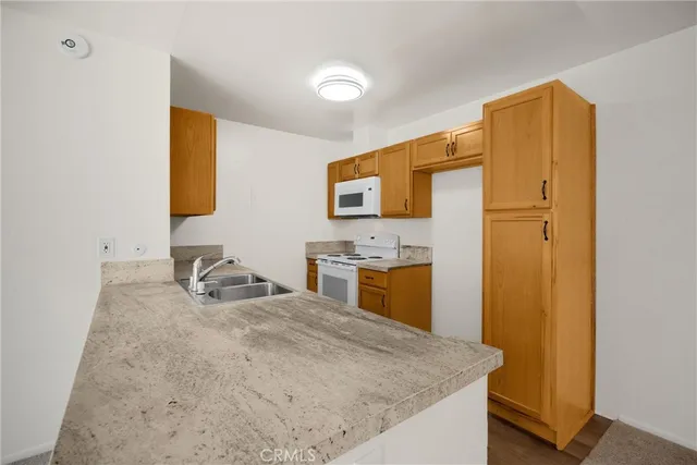 a en suite bathroom with a granite countertop sink and a mirror
