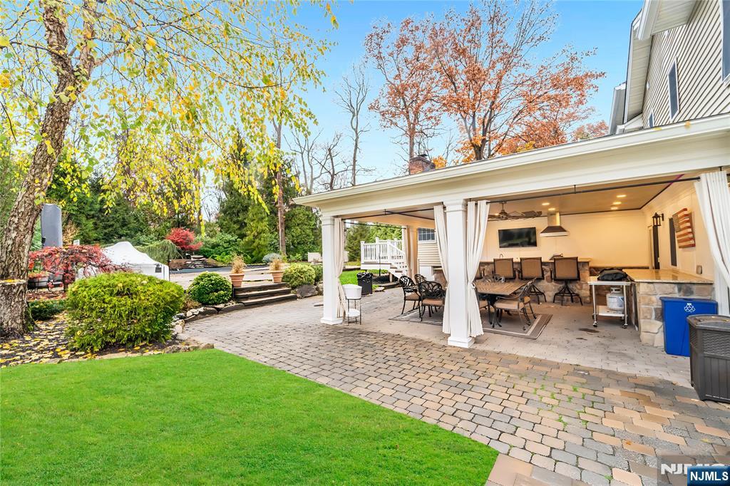 854 Cambridge Road River Vale, NJ 07675 - Photo 41 of 50 a view of a patio with table and chairs potted plants and large tree