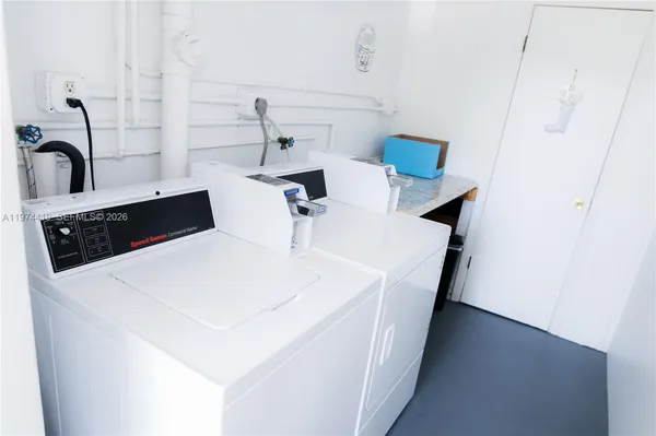 a kitchen with a sink and white cabinets