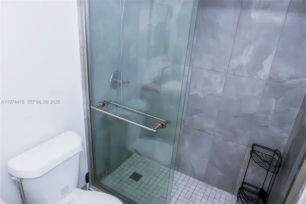 a bathroom with a toilet and a shower