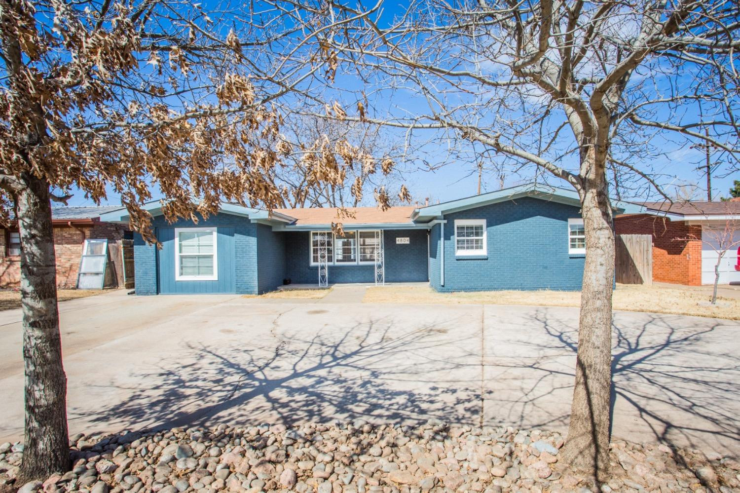 4804 44th Street Lubbock, TX 79414 - Photo 1 of 32 a front view of a house with a yard covered in snow