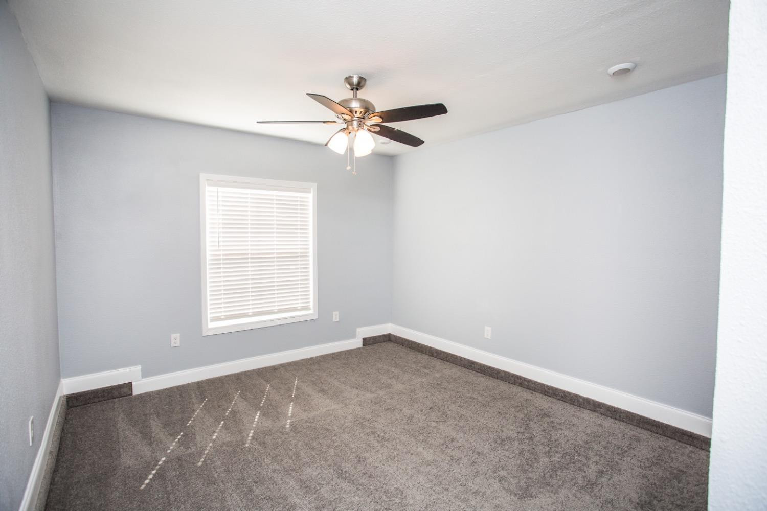 4804 44th Street Lubbock, TX 79414 - Photo 13 of 32 an empty room with windows and fan