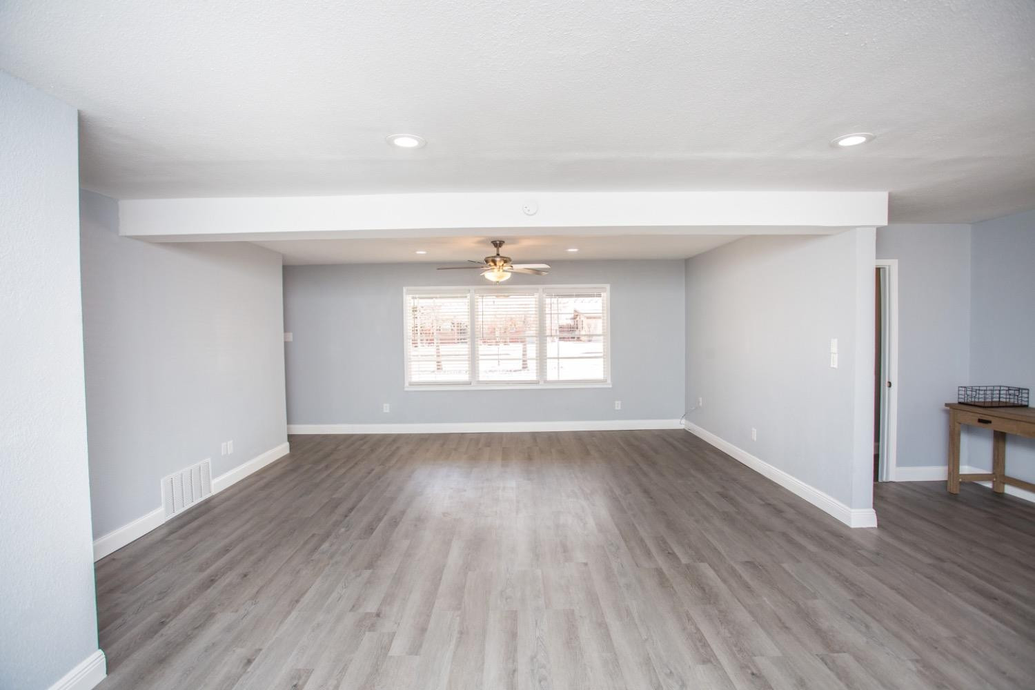 4804 44th Street Lubbock, TX 79414 - Photo 17 of 32 an empty room with wooden floor and windows