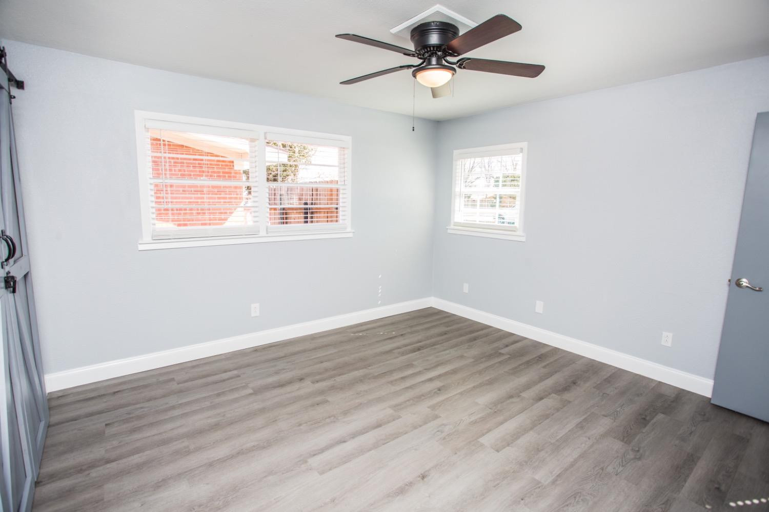 4804 44th Street Lubbock, TX 79414 - Photo 20 of 32 a view of an empty room with wooden floor and a window