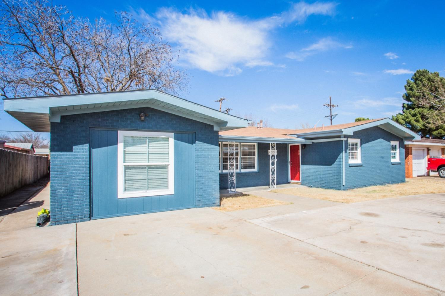 4804 44th Street Lubbock, TX 79414 - Photo 2 of 32 a front view of a house with a yard and garage