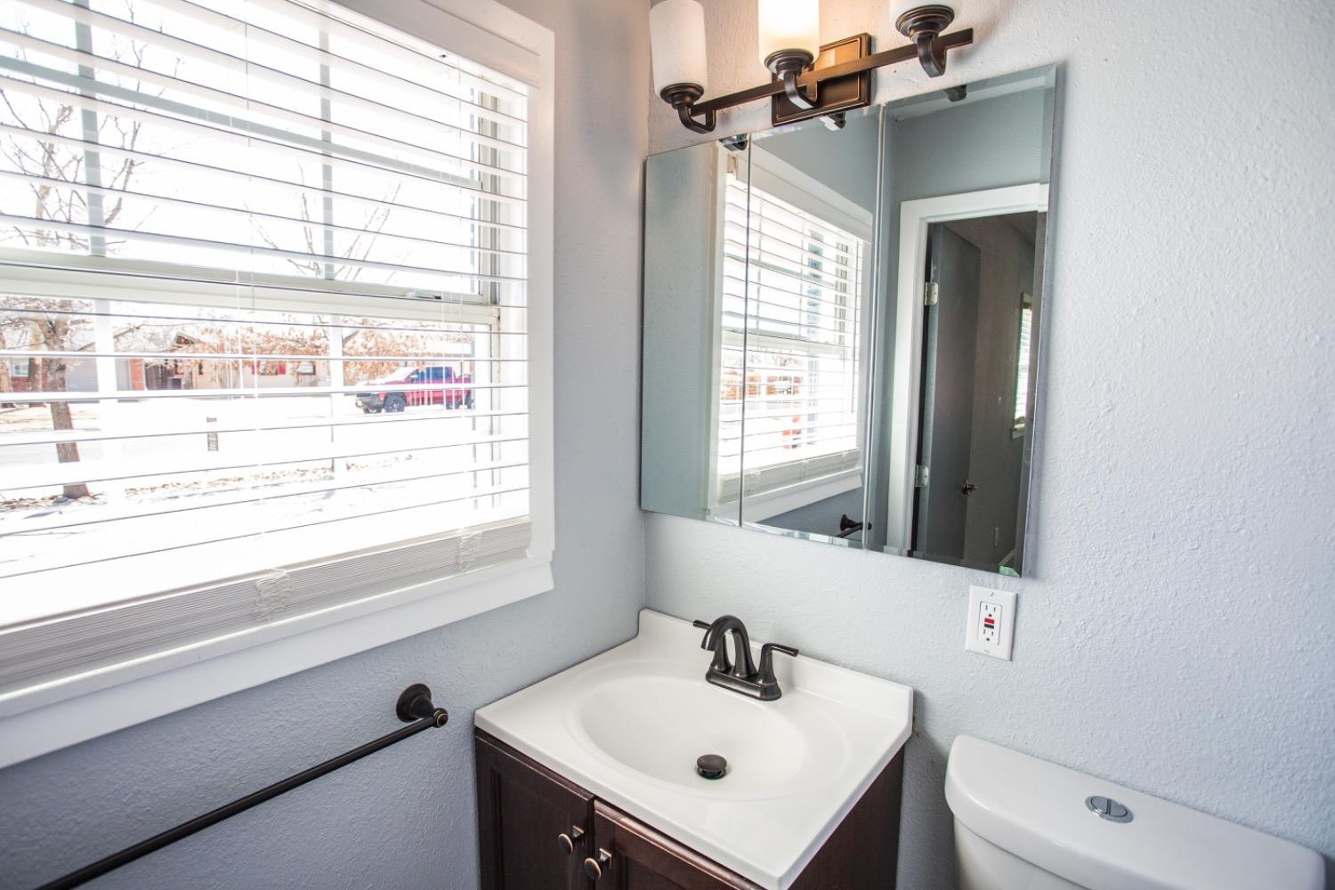 4804 44th Street Lubbock, TX 79414 - Photo 22 of 32 a bathroom with a sink and a toilet