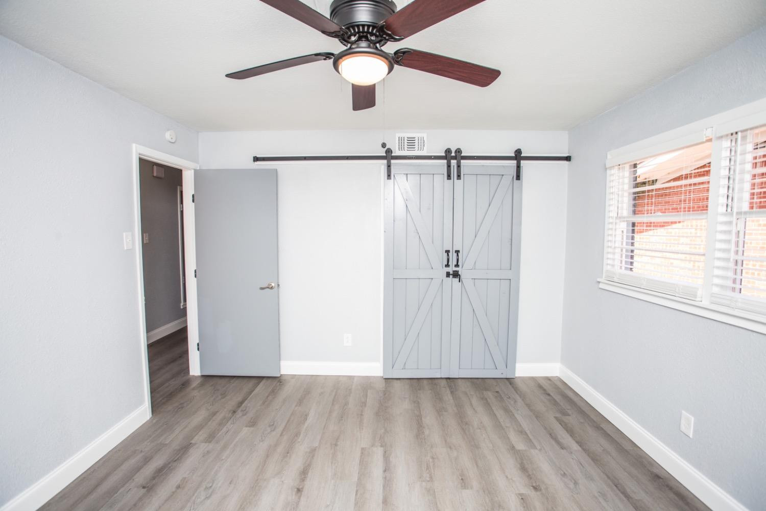 4804 44th Street Lubbock, TX 79414 - Photo 24 of 32 a view of a room with wooden floor fan and a window