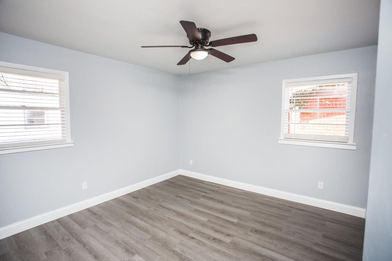 4804 44th Street Lubbock, TX 79414 - Photo 25 of 32 a view of a room with wooden floor and a window