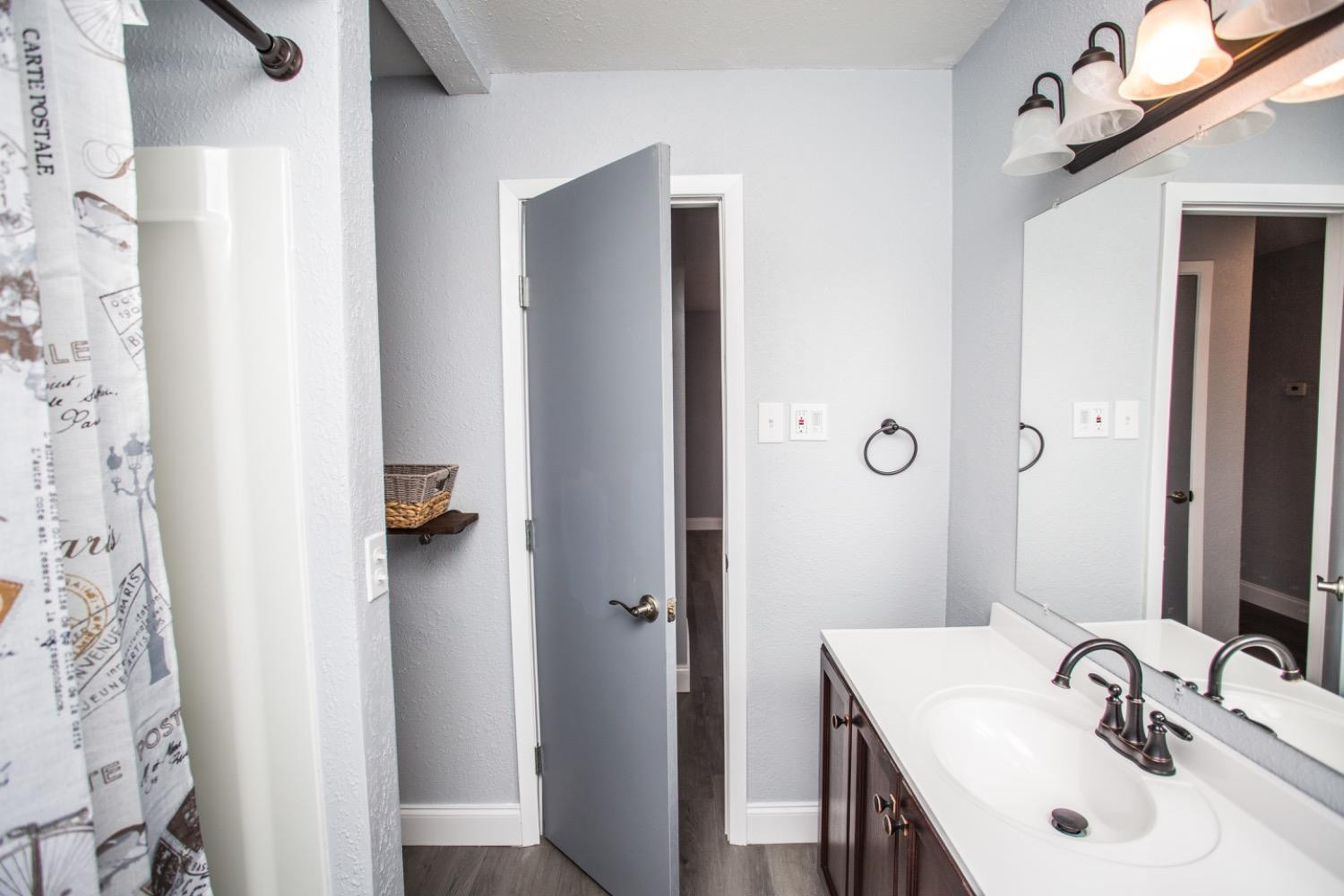4804 44th Street Lubbock, TX 79414 - Photo 31 of 32 a bathroom with a sink and a mirror