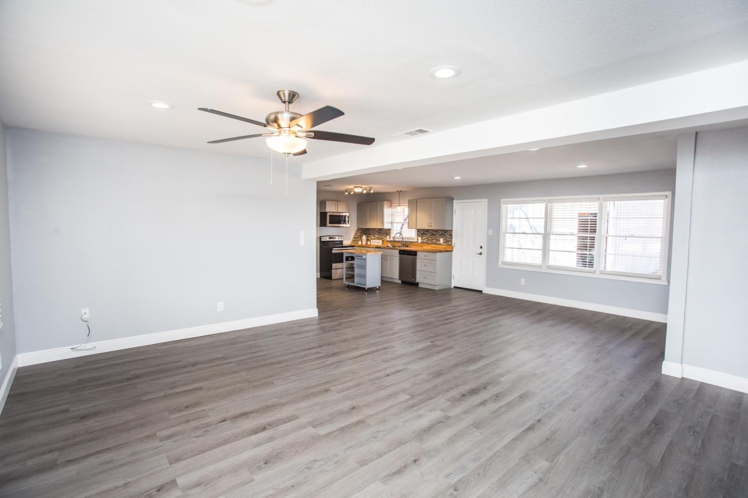 4804 44th Street Lubbock, TX 79414 - Photo 5 of 32 a view of an empty room with a window and wooden floor