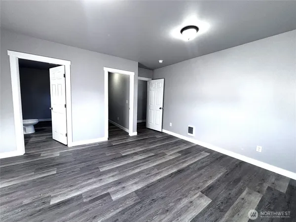 a view of a room with wooden floor