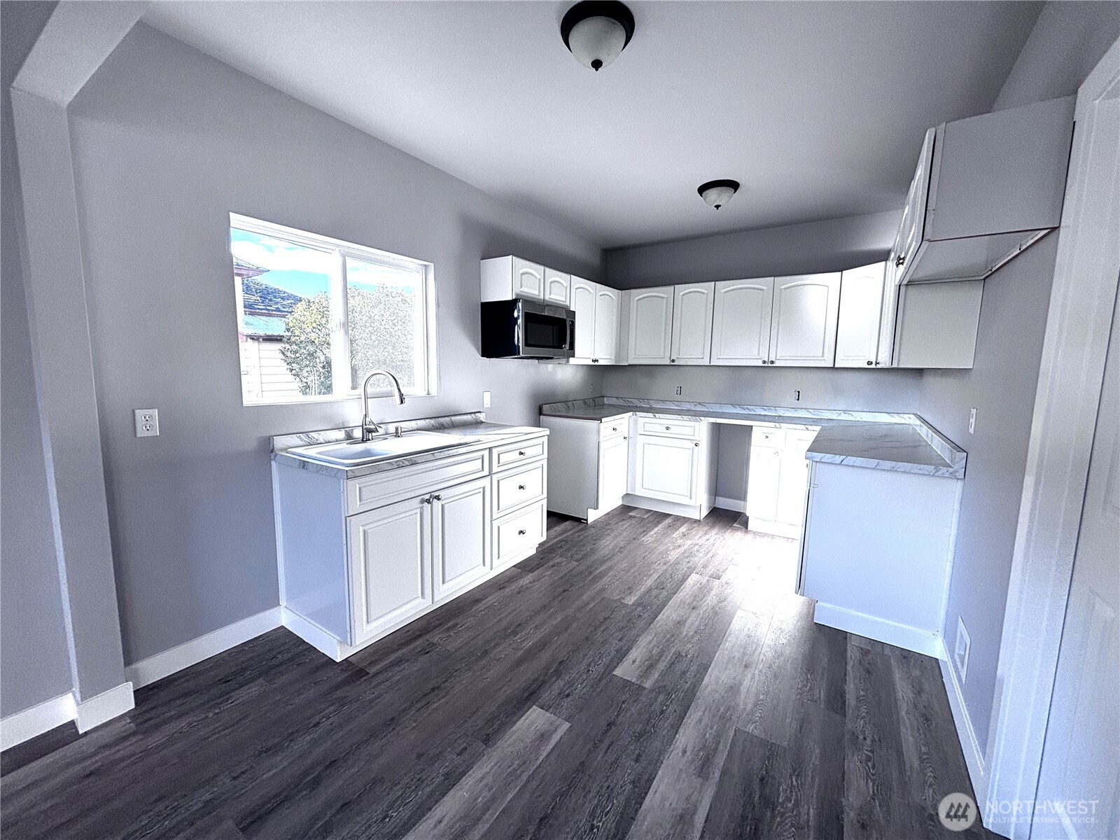 207 North Birch Street Odessa, WA 99159 - Photo 20 of 28 a kitchen with a sink a window stainless steel appliances and cabinets