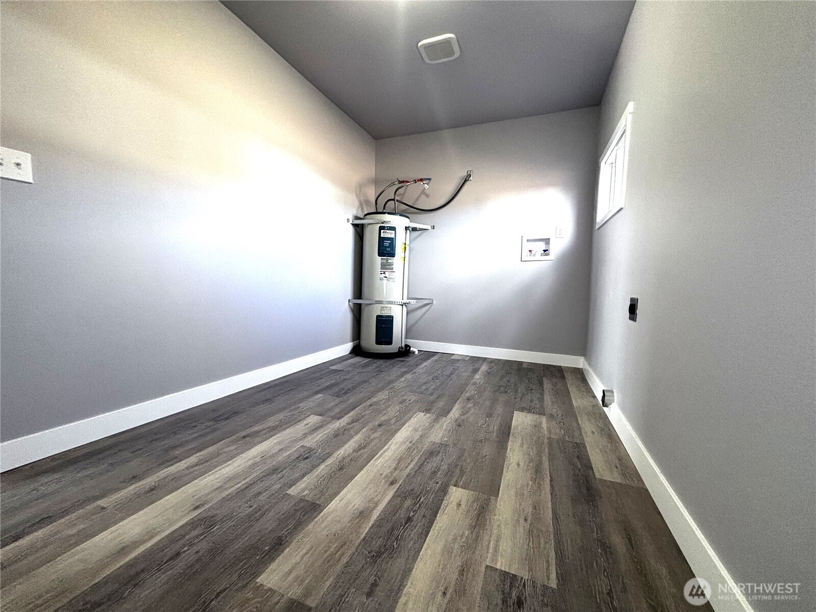 207 North Birch Street Odessa, WA 99159 - Photo 28 of 28 a view of a room with wooden floor and a ceiling fan