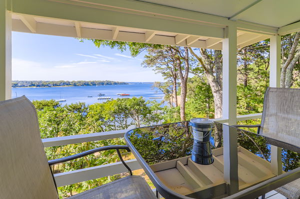 217 Barnes Road Oak Bluffs, MA 02557 - Photo 50 of 60 a view of a couple of people sitting on a balcony