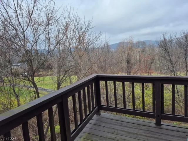 a balcony with wooden floor and fence