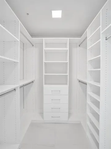 a bathroom with a sink vanity granite tub shower and a mirror