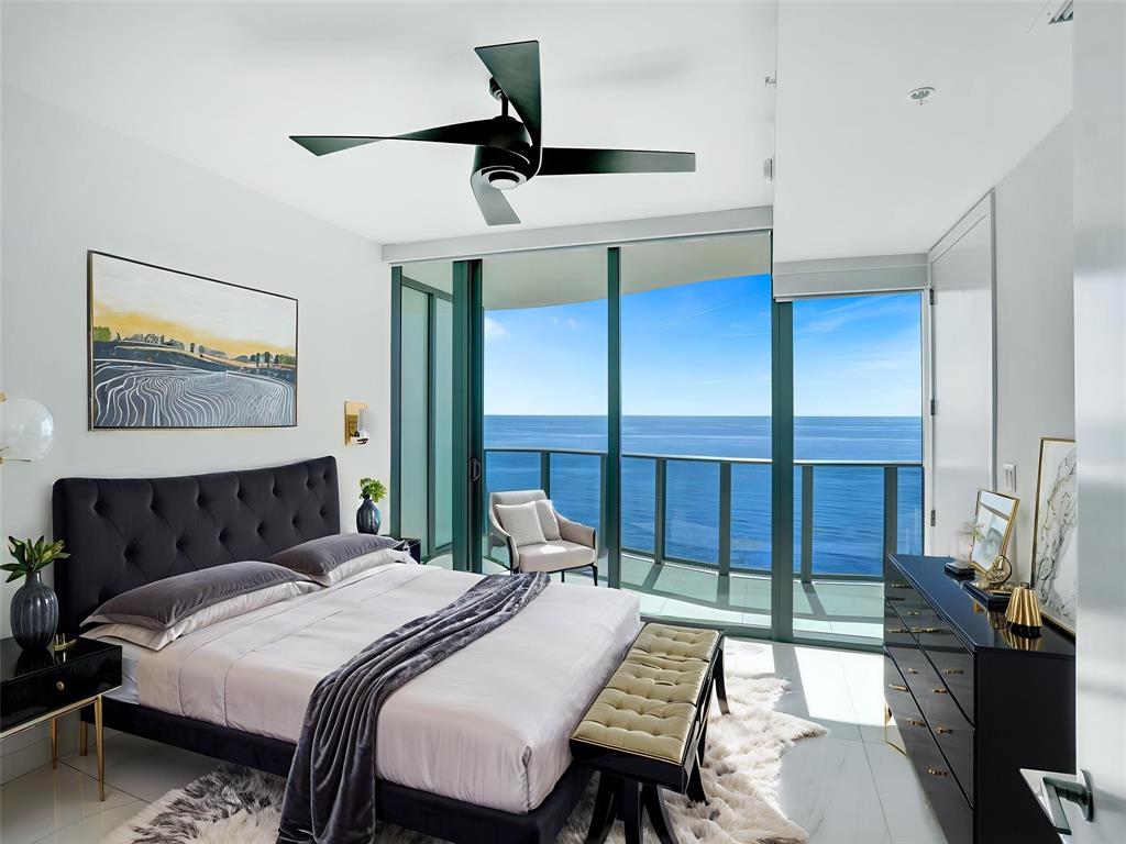 900 North Ocean Boulevard, Unit 1405 Pompano Beach, FL 33062 - Photo 30 of 67 a bedroom with a bed a desk and chair