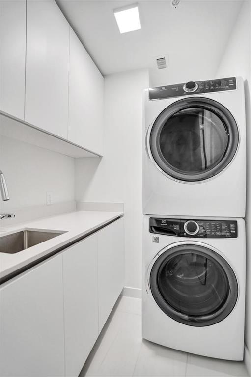 900 North Ocean Boulevard, Unit 1405 Pompano Beach, FL 33062 - Photo 37 of 67 a utility room with sink dryer and washer