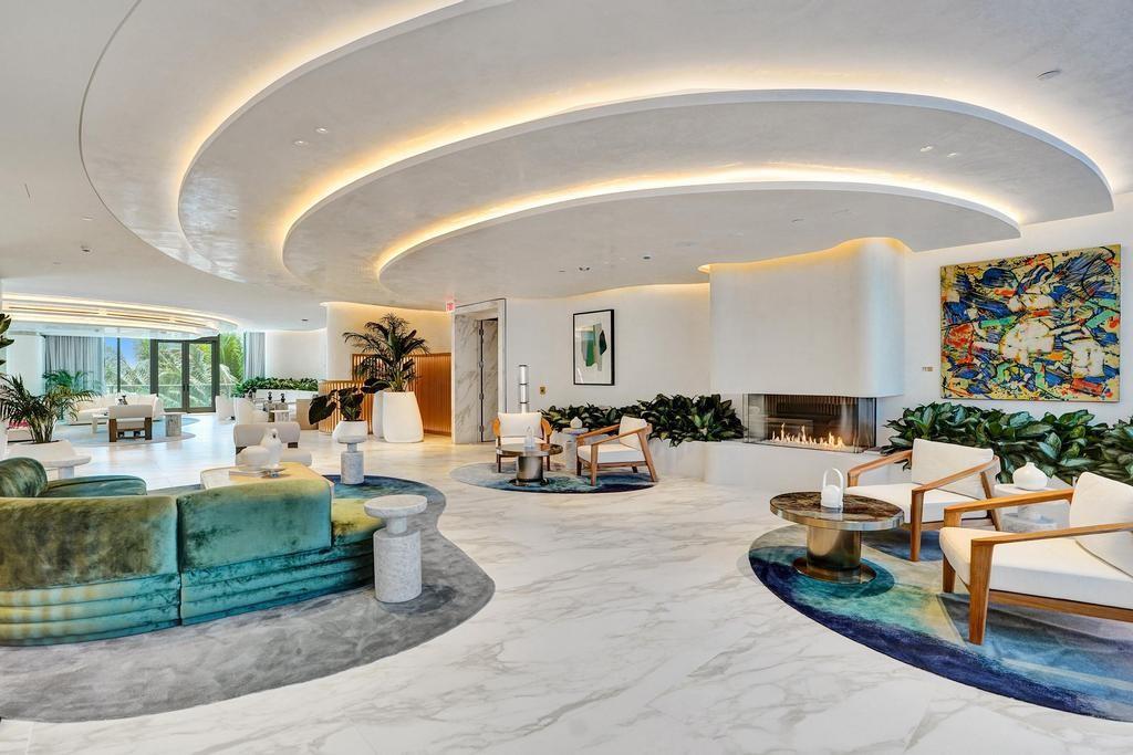 900 North Ocean Boulevard, Unit 1405 Pompano Beach, FL 33062 - Photo 46 of 67 a living room with furniture and a floor to ceiling window