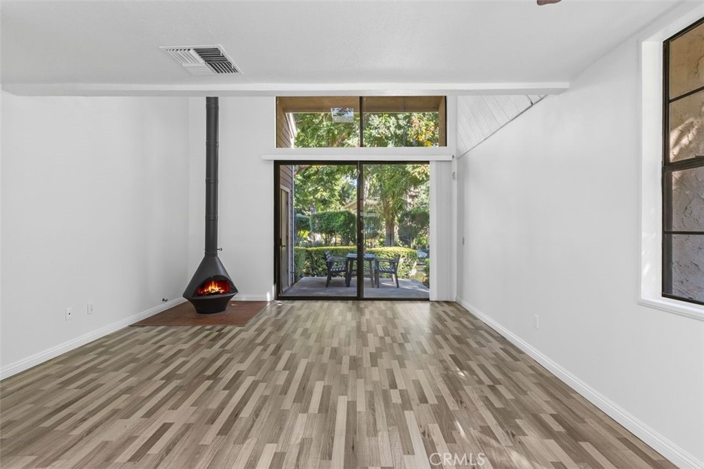 37 Lakepines Irvine, CA 92620 - Photo 11 of 55 a view of an empty room with wooden floor and a window