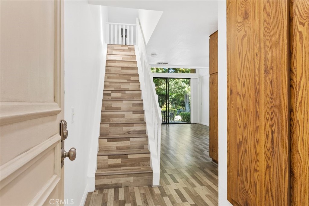 37 Lakepines Irvine, CA 92620 - Photo 4 of 55 a view of a hallway with wooden floor and entryway
