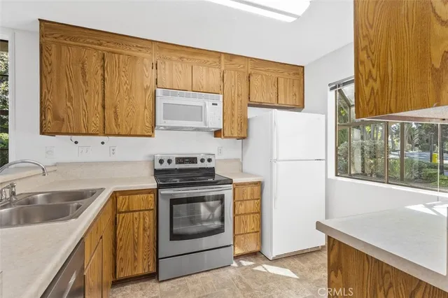 a kitchen with a refrigerator stove and sink