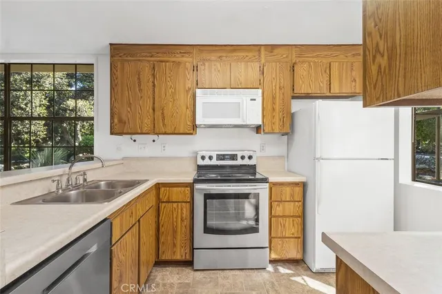 a kitchen with a sink stove and refrigerator