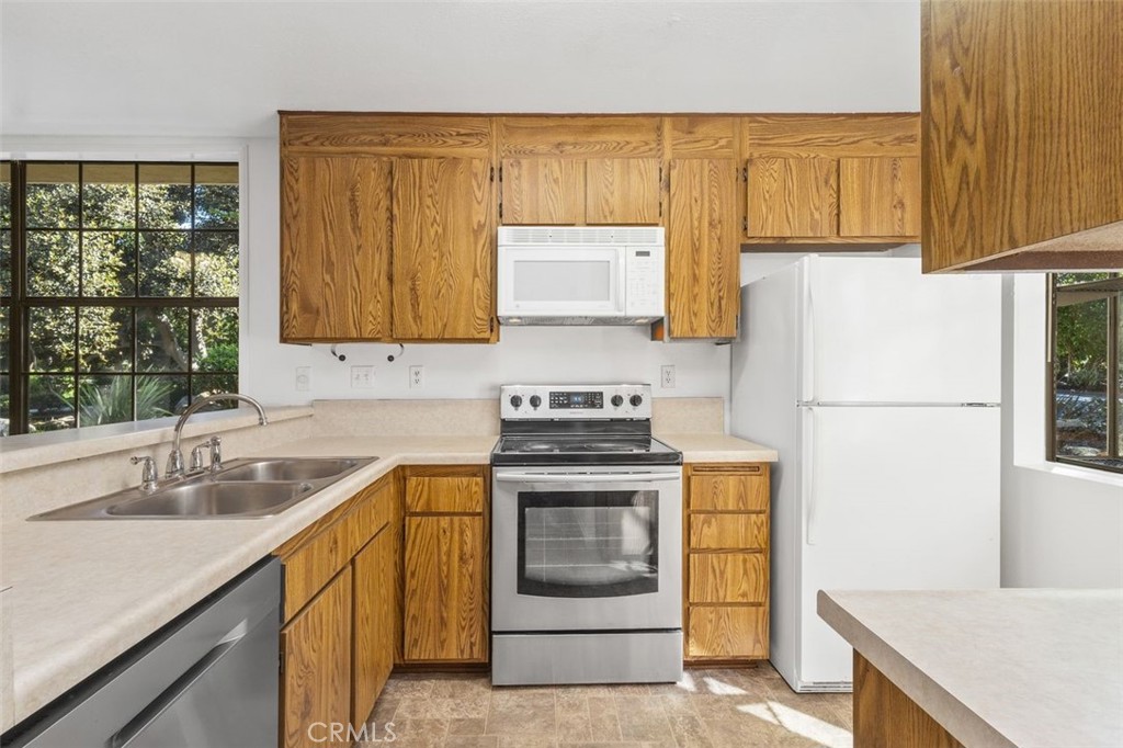 37 Lakepines Irvine, CA 92620 - Photo 6 of 55 a kitchen with a sink stove and refrigerator