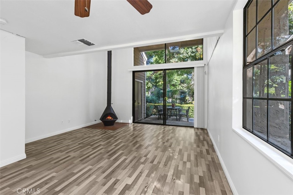 37 Lakepines Irvine, CA 92620 - Photo 10 of 55 a view of an empty room with wooden floor and a window