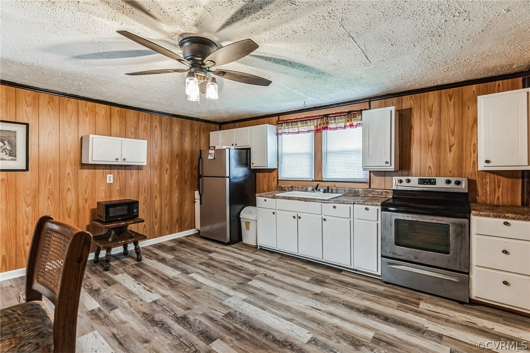 381 Moses Mill Road Chatham, VA 24531 - Photo 11 of 31 a open kitchen with stainless steel appliances granite countertop a stove top oven a refrigerator cabinets and dining table with wooden floor