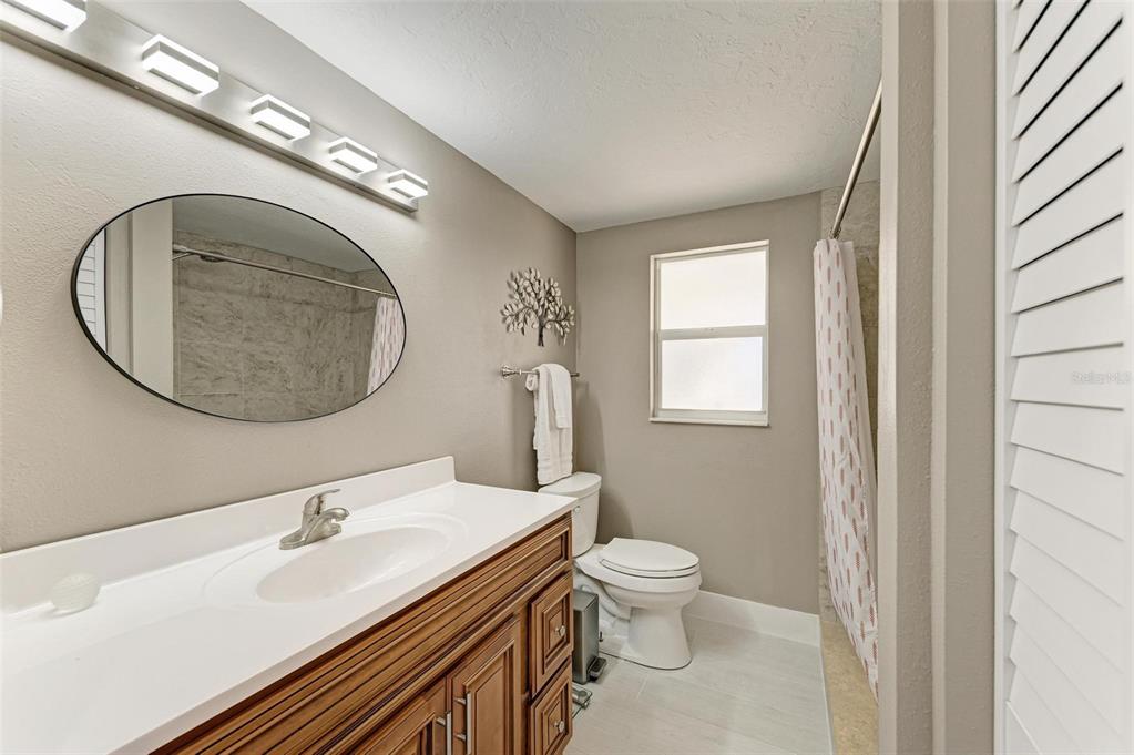 3311 Water Street Ellenton, FL 34222 - Photo 19 of 41 a bathroom with a toilet a sink and a mirror
