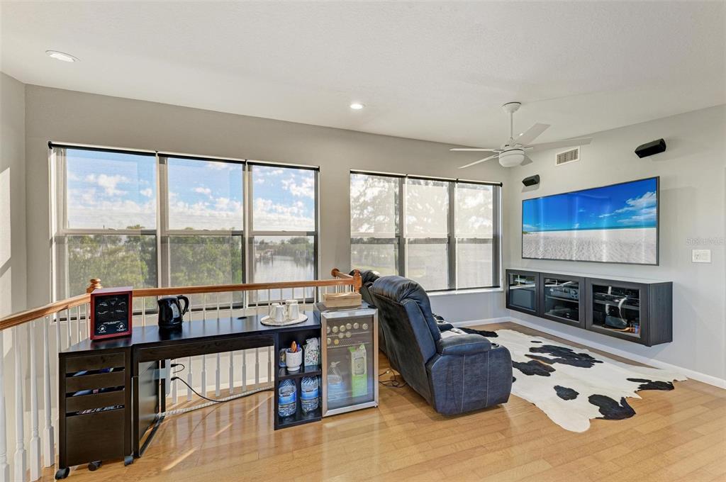 3311 Water Street Ellenton, FL 34222 - Photo 24 of 41 a living room with furniture a flat screen tv and a floor to ceiling window