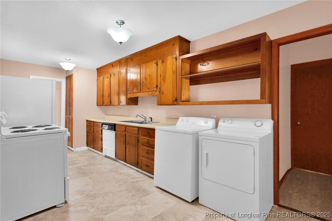 215 South 7th Street Spring Lake, NC 28390 - Photo 15 of 37 a kitchen with a stove and a refrigerator