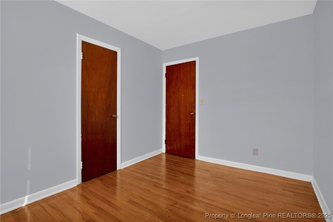 215 South 7th Street Spring Lake, NC 28390 - Photo 23 of 37 a view of an empty room with wooden floor and a window