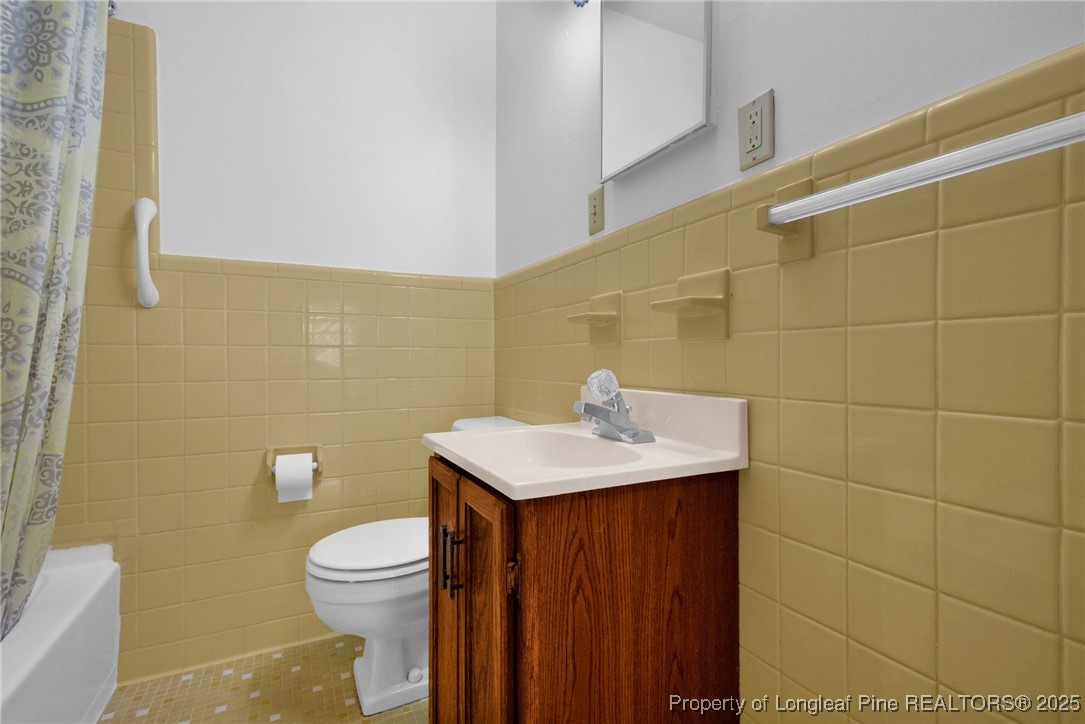 215 South 7th Street Spring Lake, NC 28390 - Photo 24 of 37 a bathroom with a sink a toilet and a mirror
