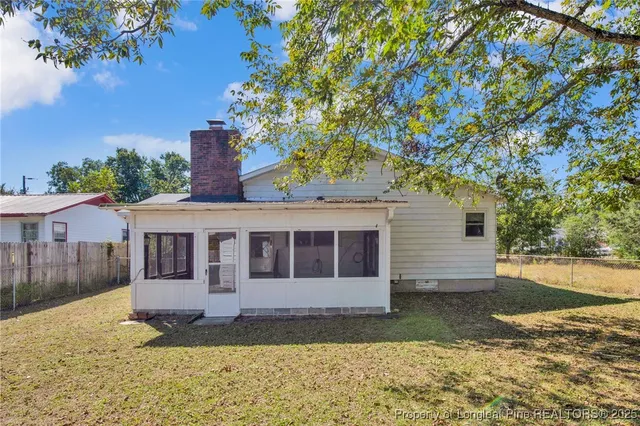 a view of a house with a yard and tree s