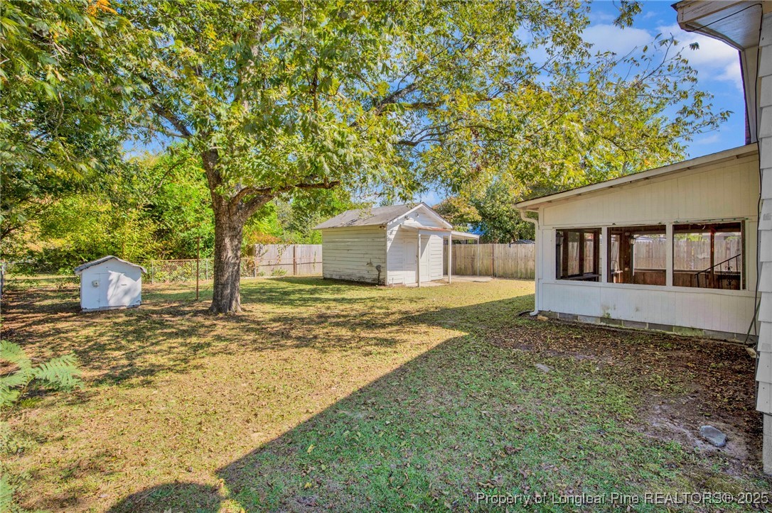 215 South 7th Street Spring Lake, NC 28390 - Photo 34 of 37 a view of a house with backyard and tree