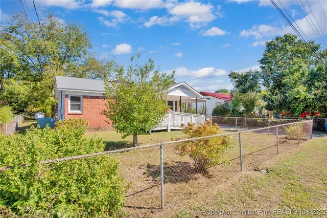 a view of house with outdoor space and seating area