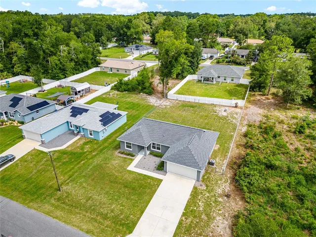 an aerial view of residential houses with yard