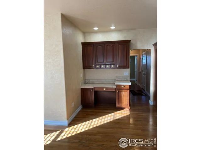 a kitchen with granite countertop a refrigerator and a stove