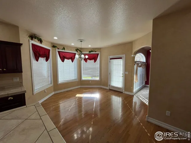 a view of a livingroom with wooden floor and window
