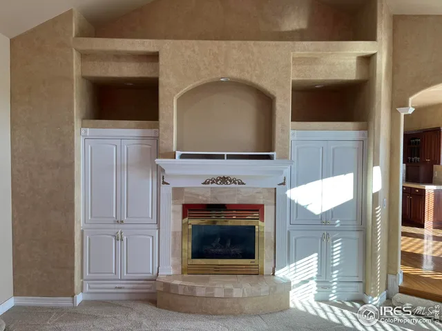 a living room with a fireplace and a fireplace